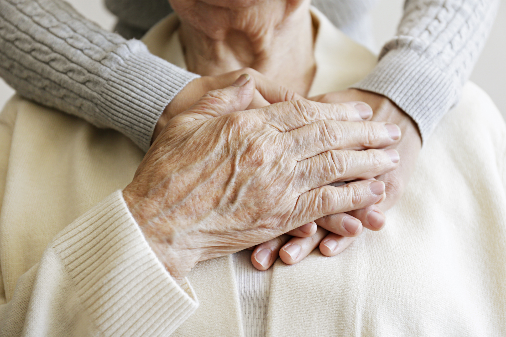 Image of hands over elderly woman's chest